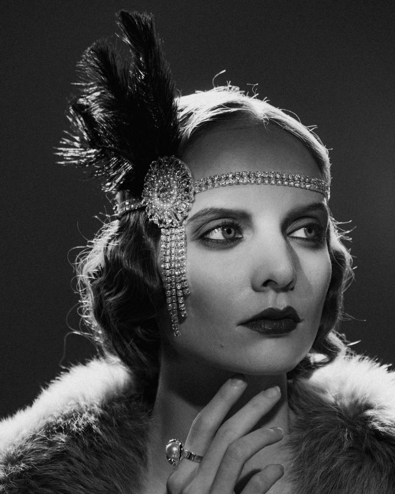 Woman in 1920s dress with a feather and headband